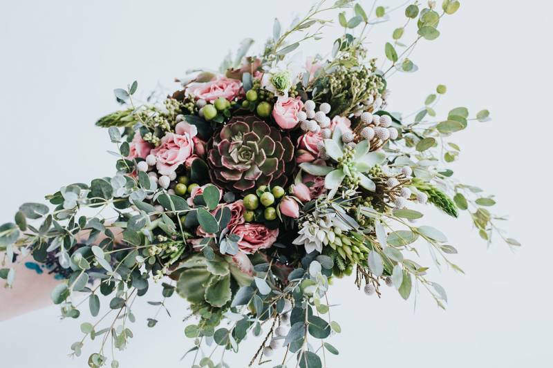 Blooming blush and green bouquet with budding irises and succulents 