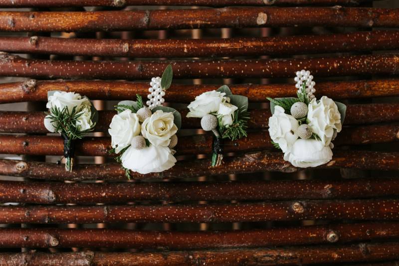 two white boutonniere and two white corsage 