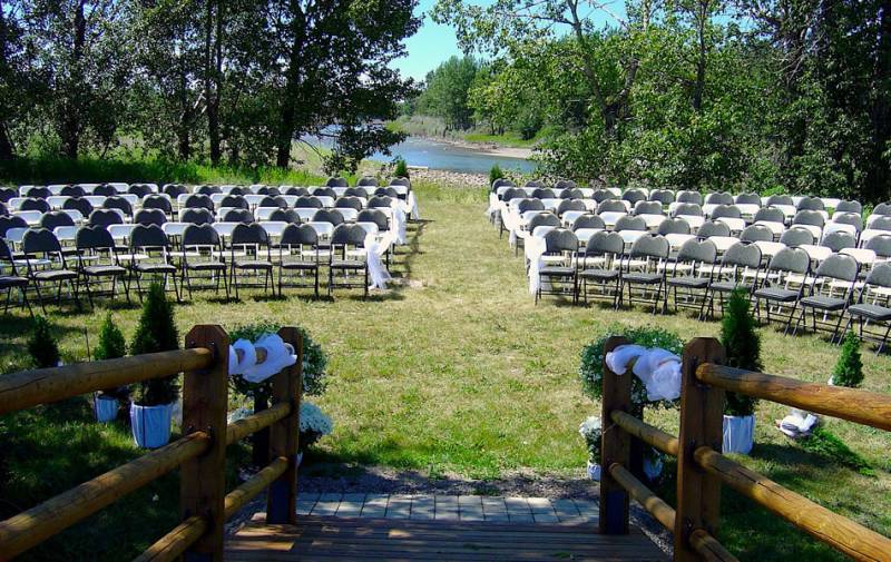 Large seating arrangement with aisle facing opposite to bow river in green field 