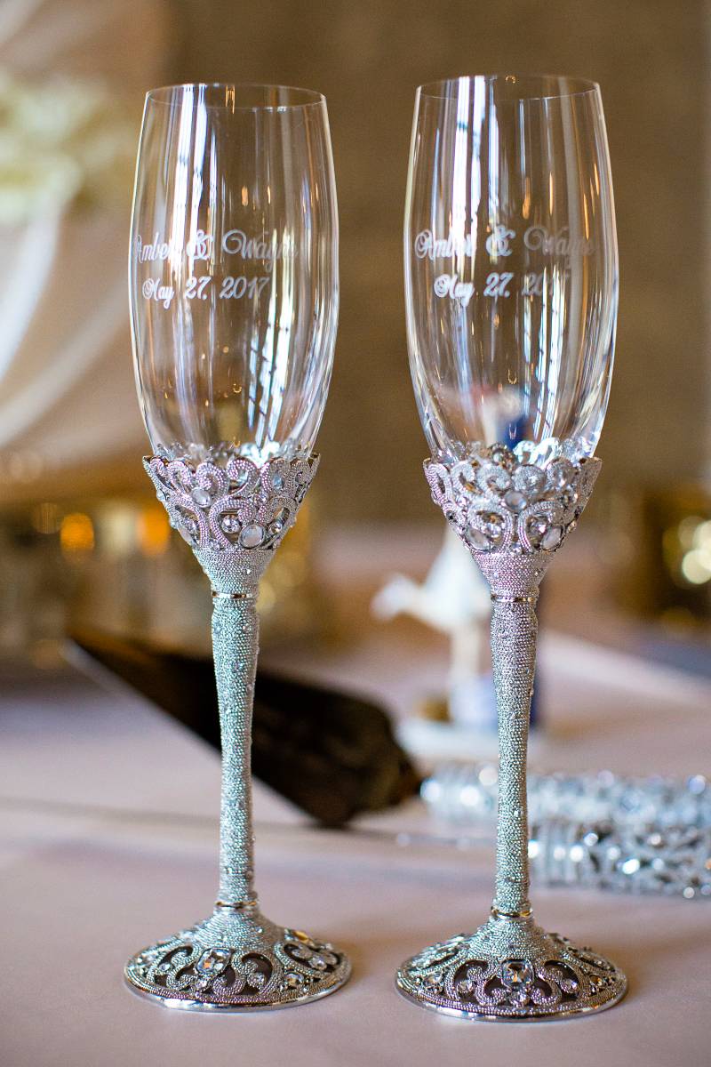 Two champagne glasses with blue and pink jewels on stem 