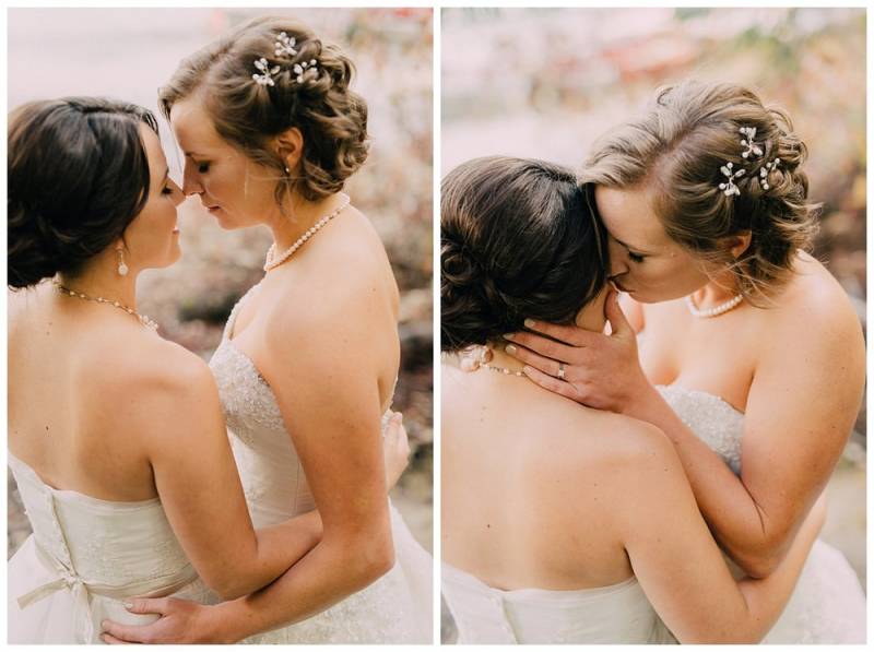 Brides kiss and embrace in white lace dresses