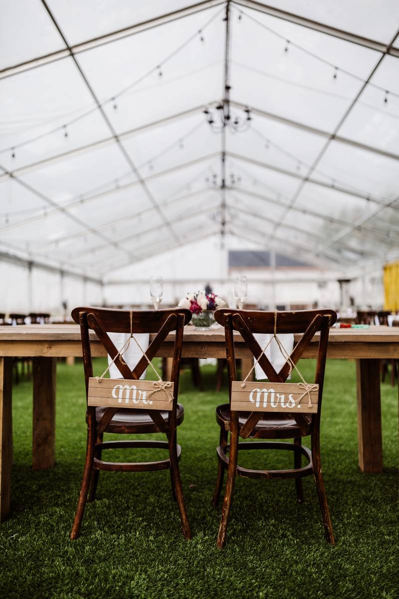 Wood Sweetheart table under clear tent with fairy lights wedding ceremony 