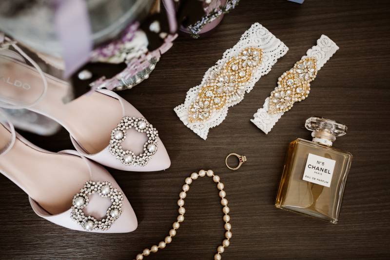 Bride jewelry and blush heel flat lay with Chanel  