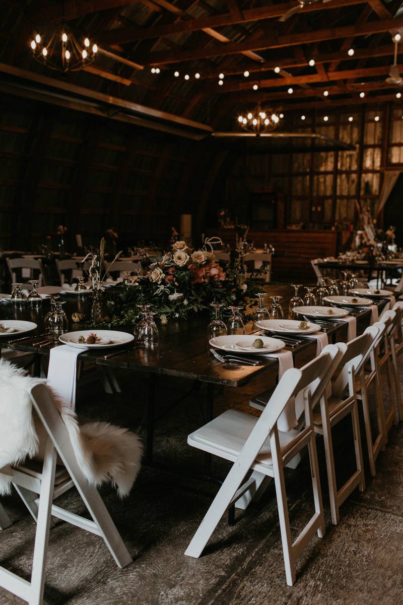 Barn Wedding reception with white table scape and fairy lights
