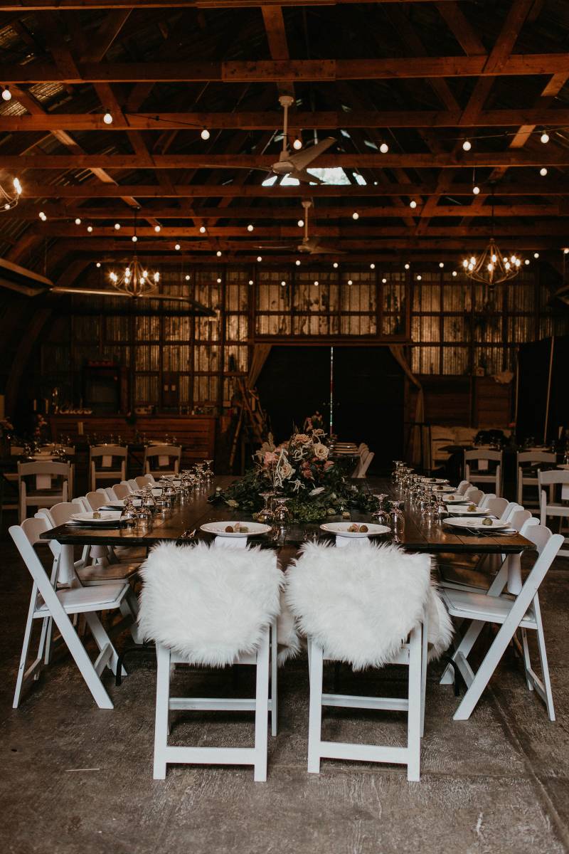 Barn Wedding reception with white table scape and fairy lights