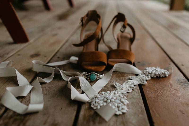 Strapped heels on wooden floor with white ribbon and lace