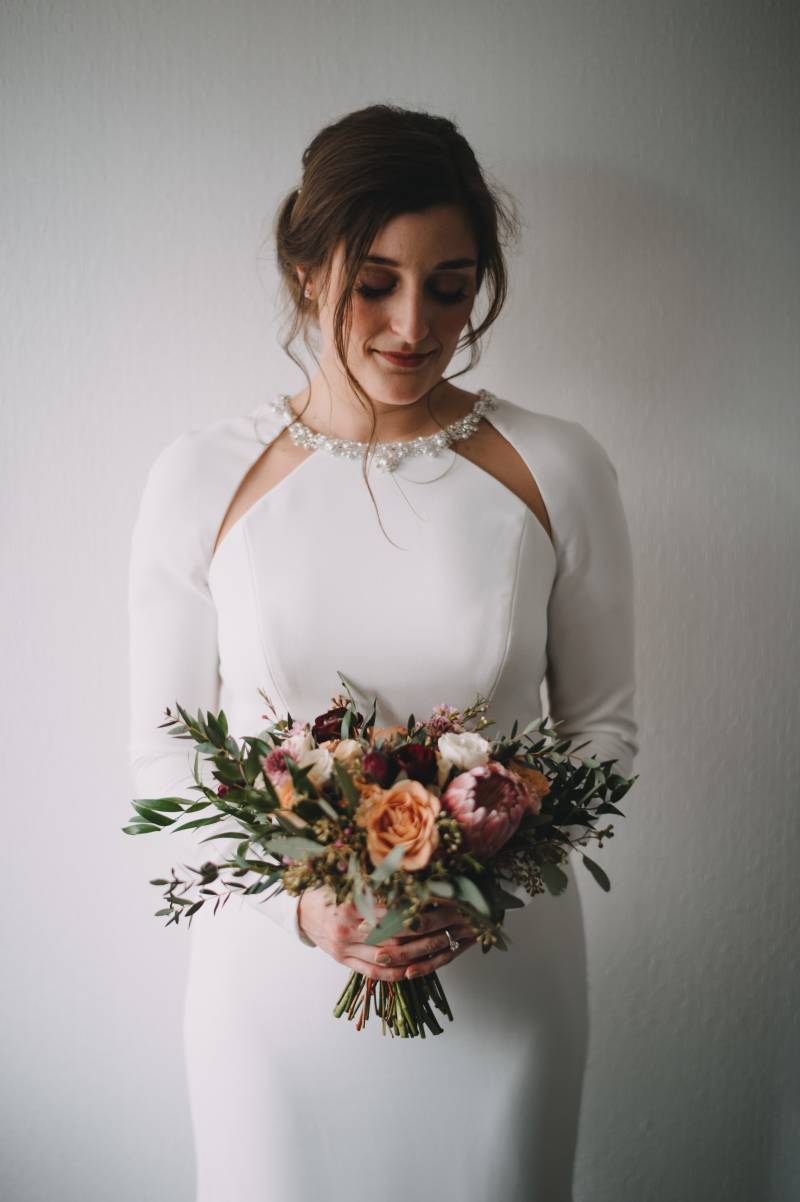 Bride in white dress holding bouquet 