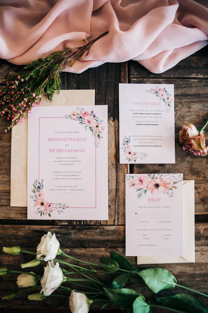 Rustic Romantic Blush and Ivory Stationery on a wood table with blush fabric and white roses