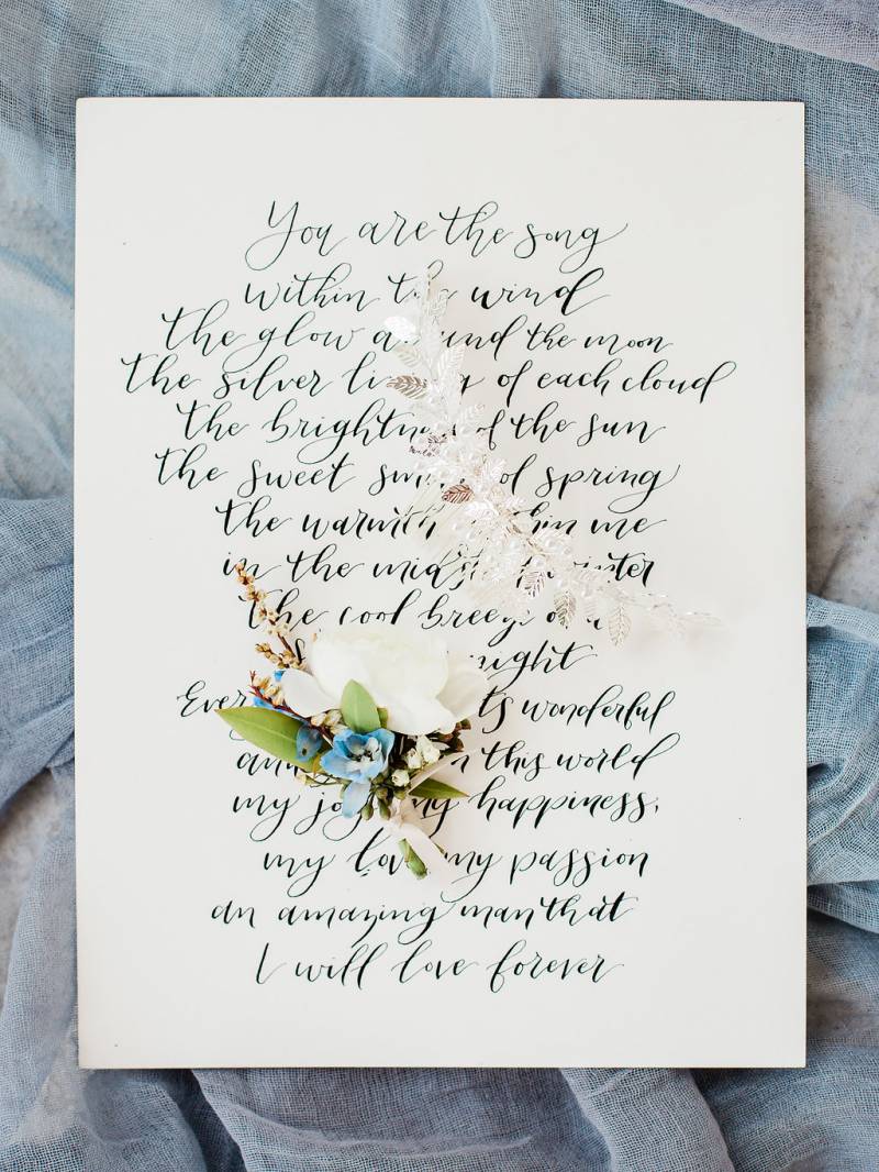 Cream white page with poem and floral arrangement on top 