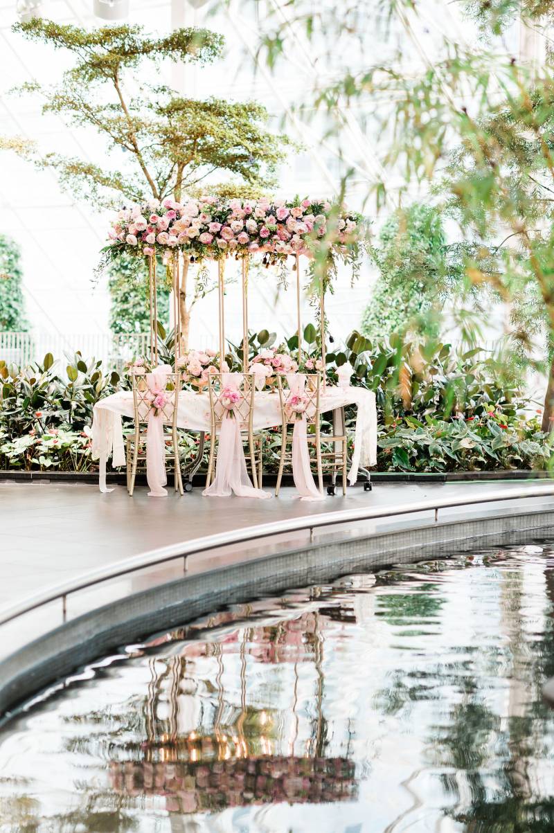 Indoor river atrium in front of blush pink and gold table 