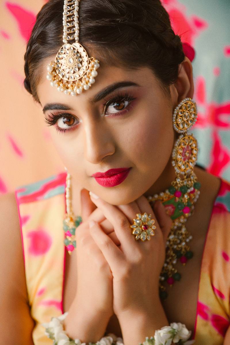 Woman with Bollywood themed jewelry and headdress 