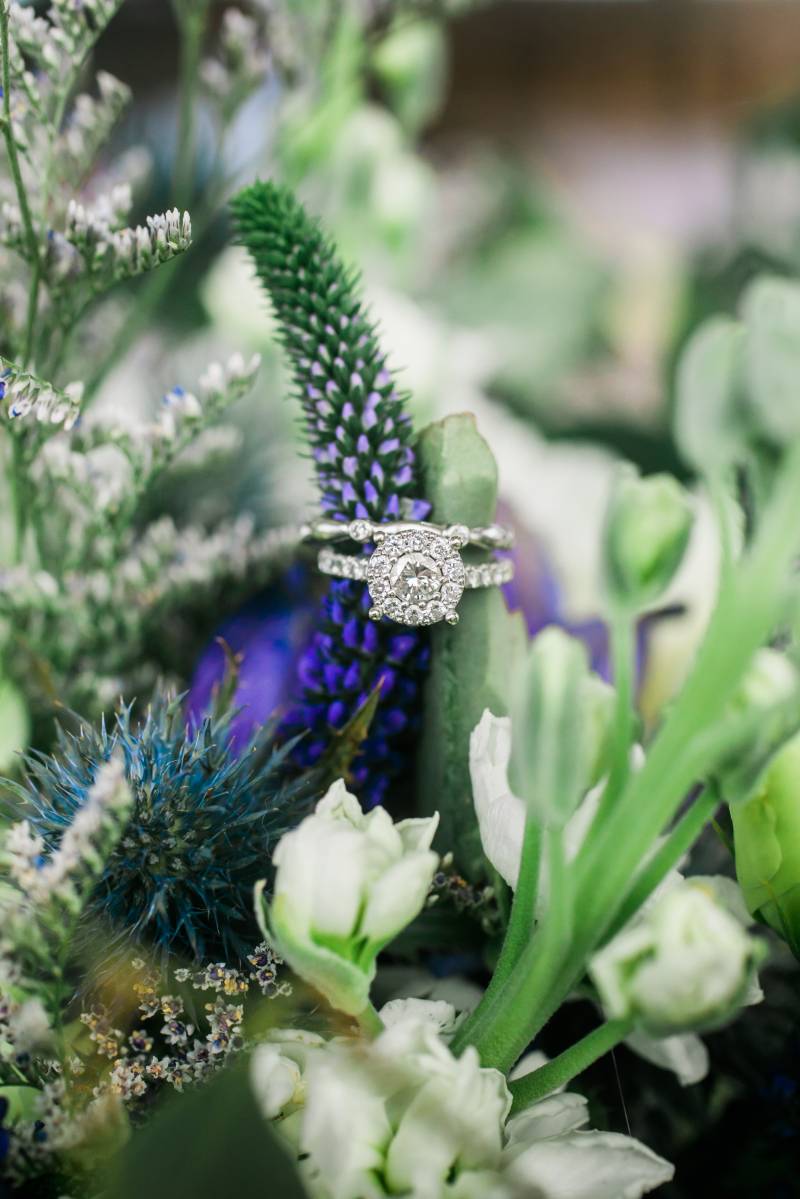 Rings stacked around lavender and green flowers