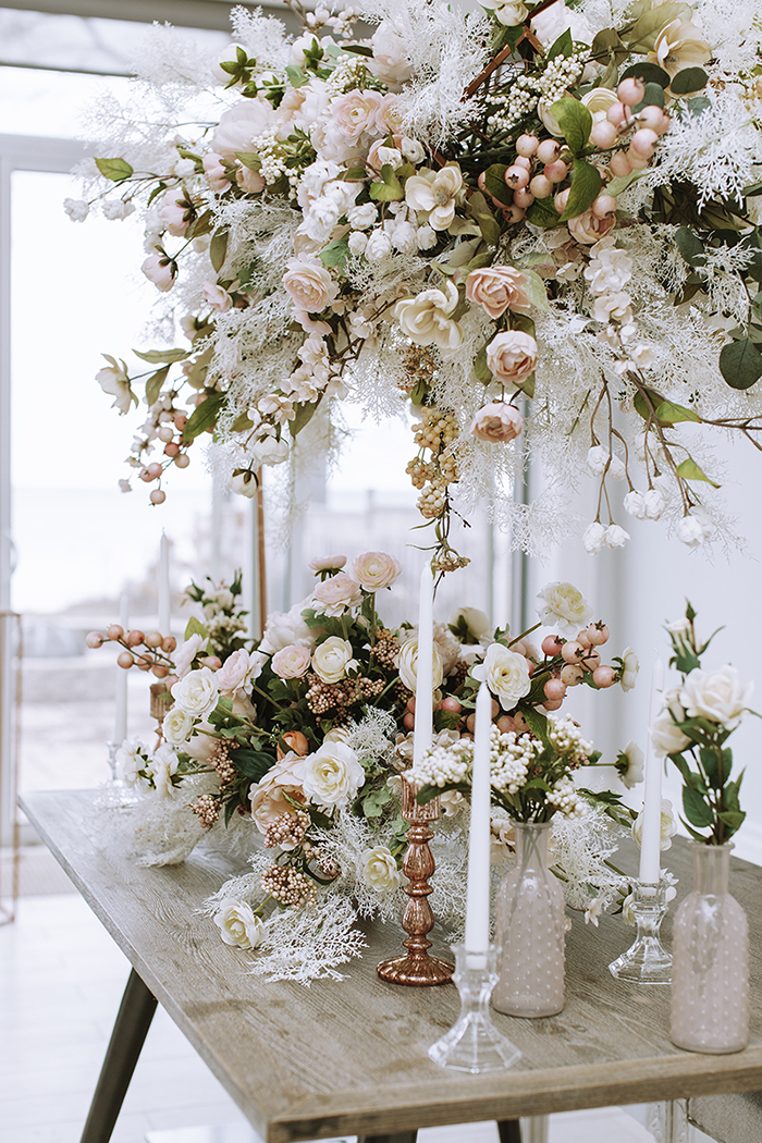 Large hanging floral arrangement over table with large blush centerpiece and candlesticks