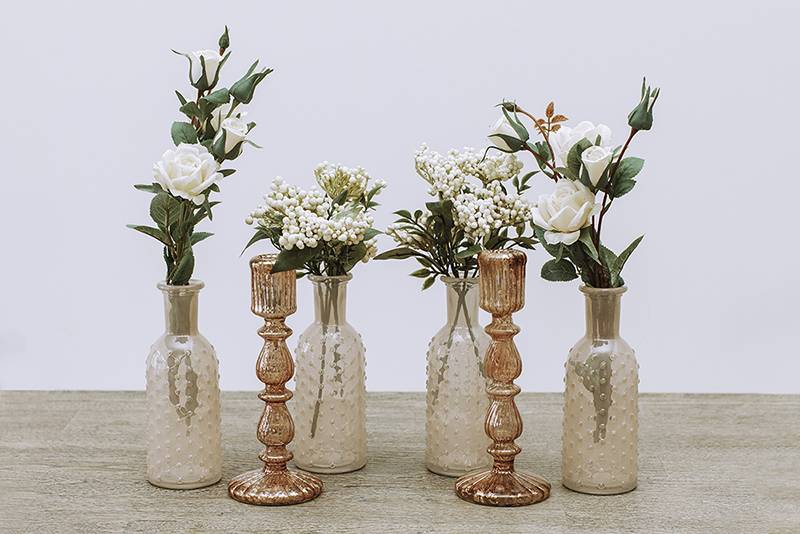 White flowers in clear bronze vases 