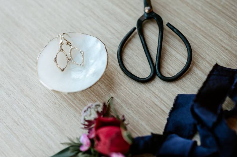 Bonsai scissors beside earrings  