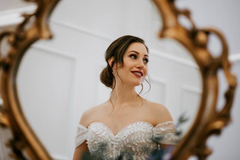 Brides reflection in mirror looking to side 