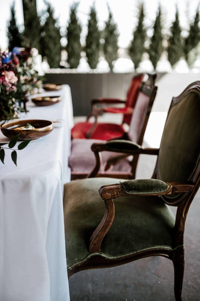 Green lavender and red seats at white table 