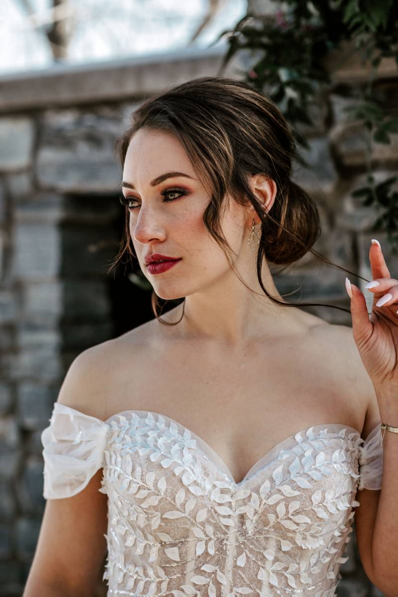 Woman in white lace dress looks into distance 