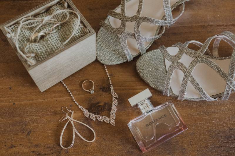 Jewelry heels and wedding ring flat lay with small box with small twine bag