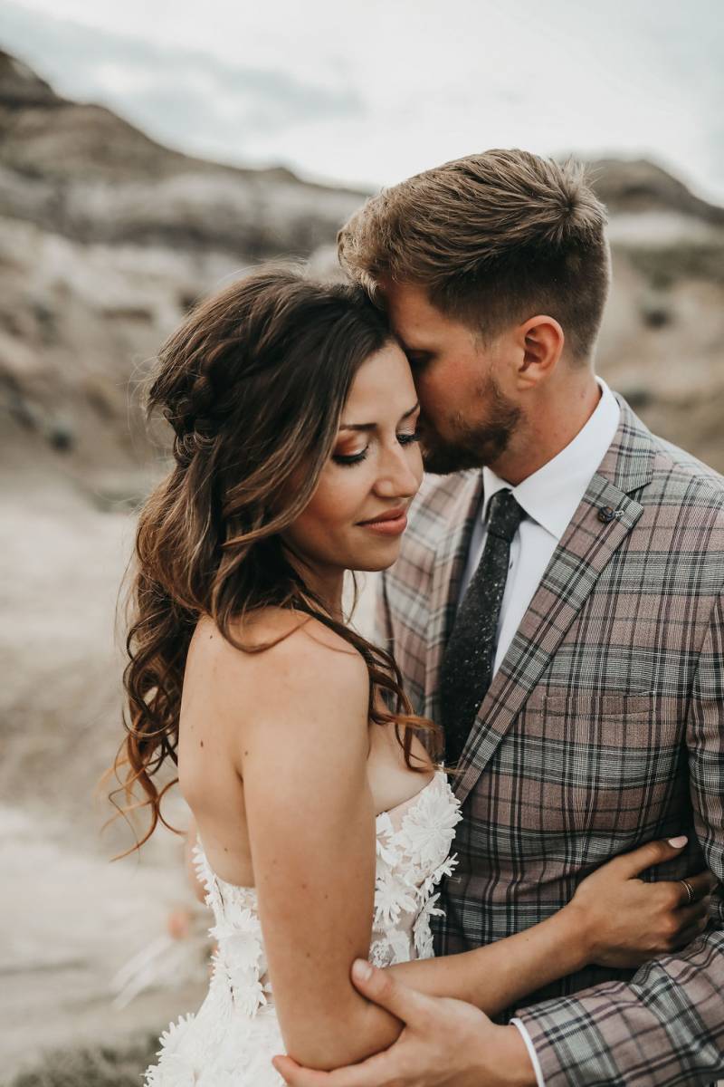 Man and woman embrace with desert background