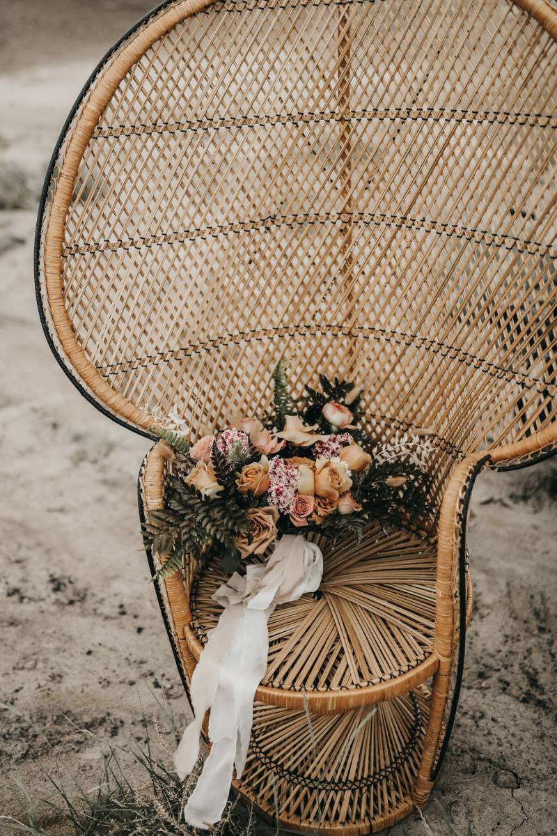 Large wicker seat with pale flowers and white ribbon on top