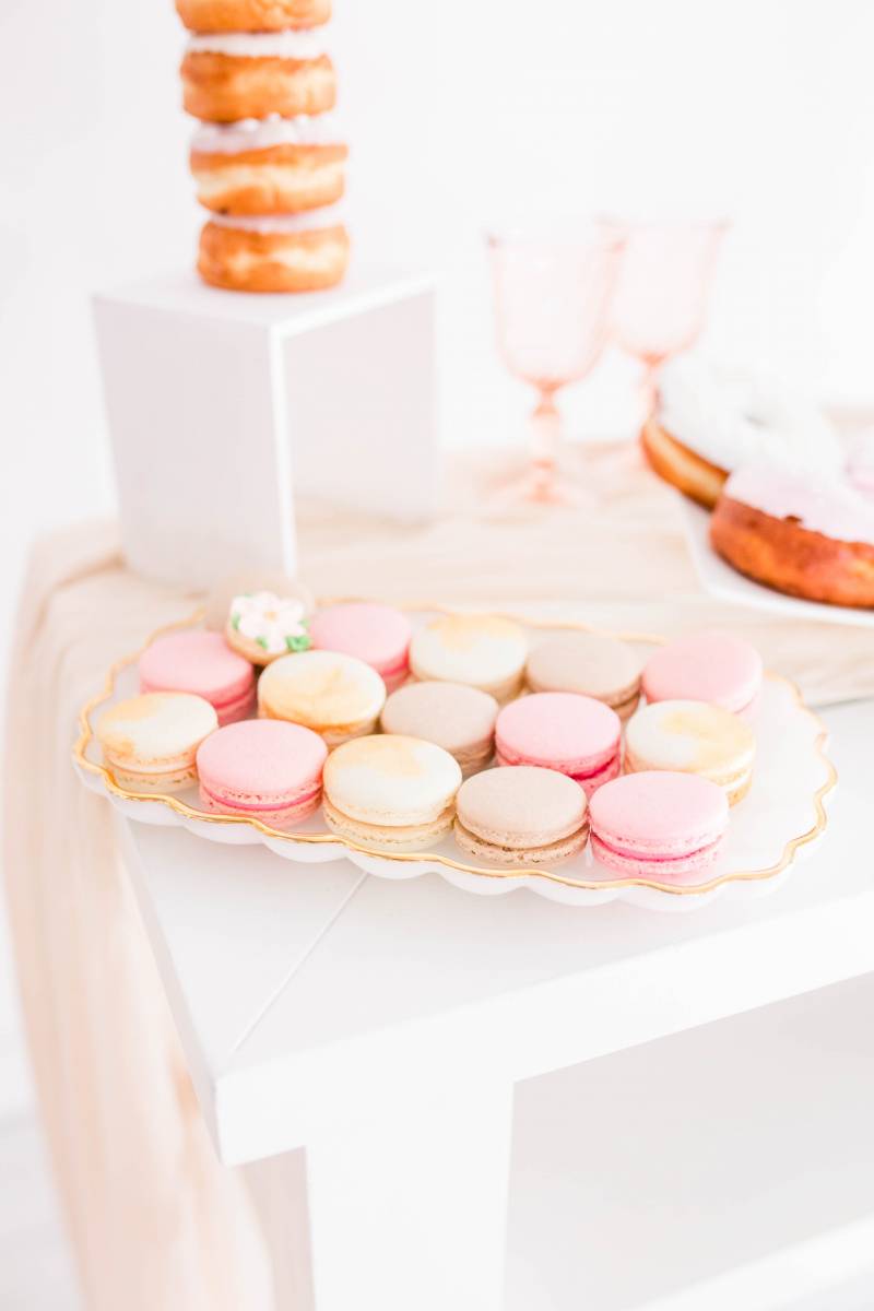 Pink and gold macaroons on white table 