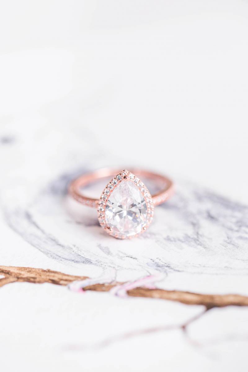 Blush pink wedding ring on marble table 