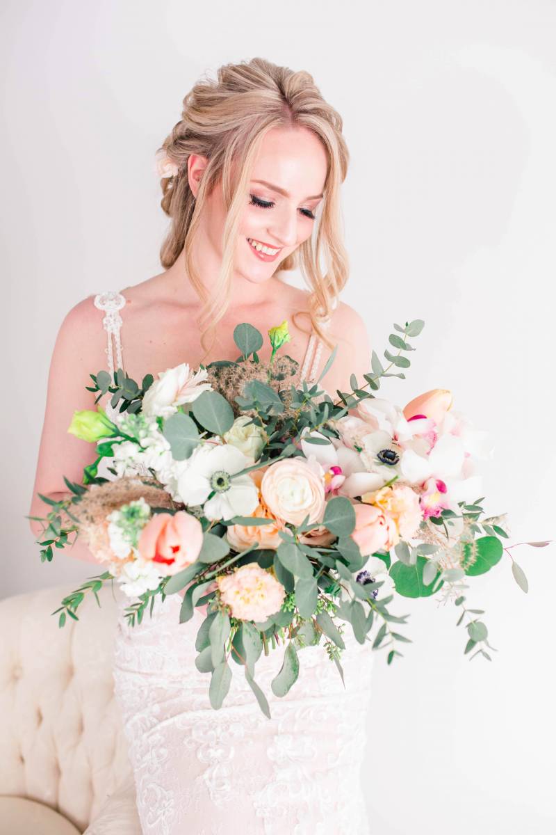 Bride holding blush pink and white bouquet 