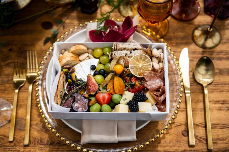 Individual Charcuterie box with gold place setting flat lay