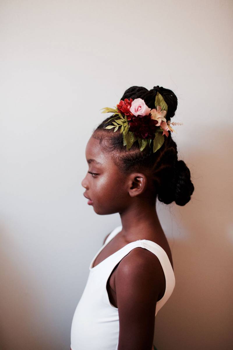 Profile of child with floral clip decoration in hair