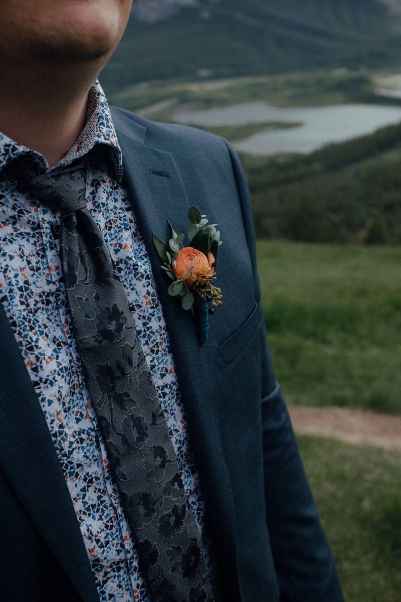Orange boutonniere on chest of groom 
