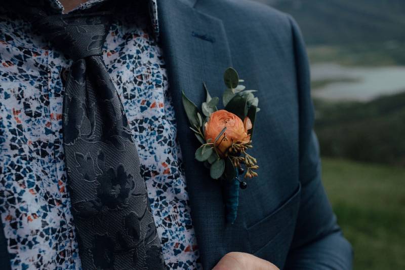 Orange boutonniere on chest of groom 