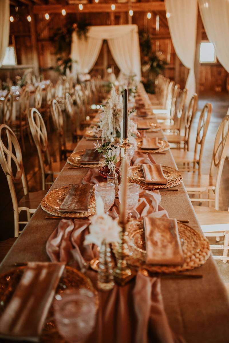 Table setting with long blush table runner and woven straw place setting