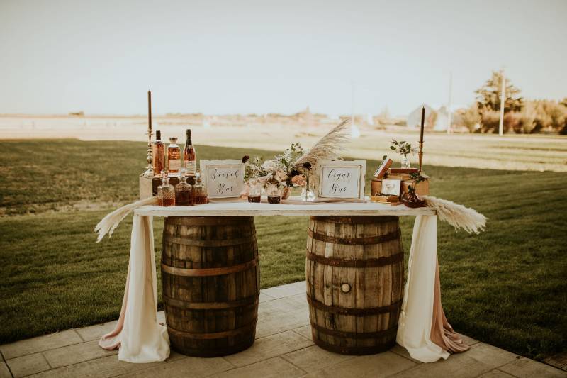 Scotch bar on wood table supported by wooden barrels 